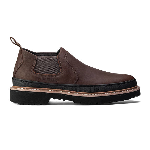 Brown Chelsea boot with black sole on a white background