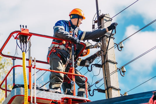 Lineman working on electrical wires with Electrical Hazard (EH) protection boots on